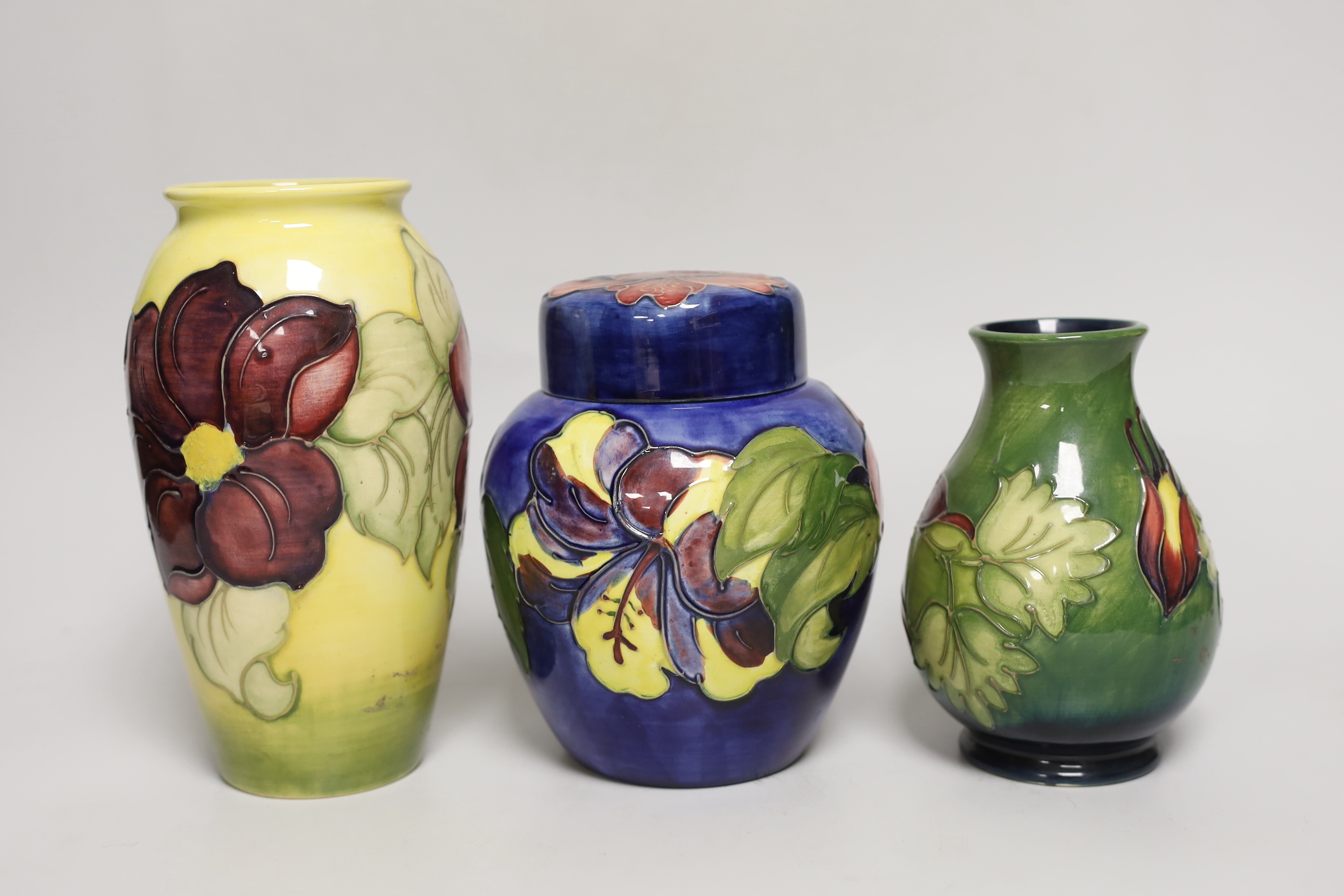 A Moorcroft hibiscus jar and cover, 16cm, an anemone vase and another